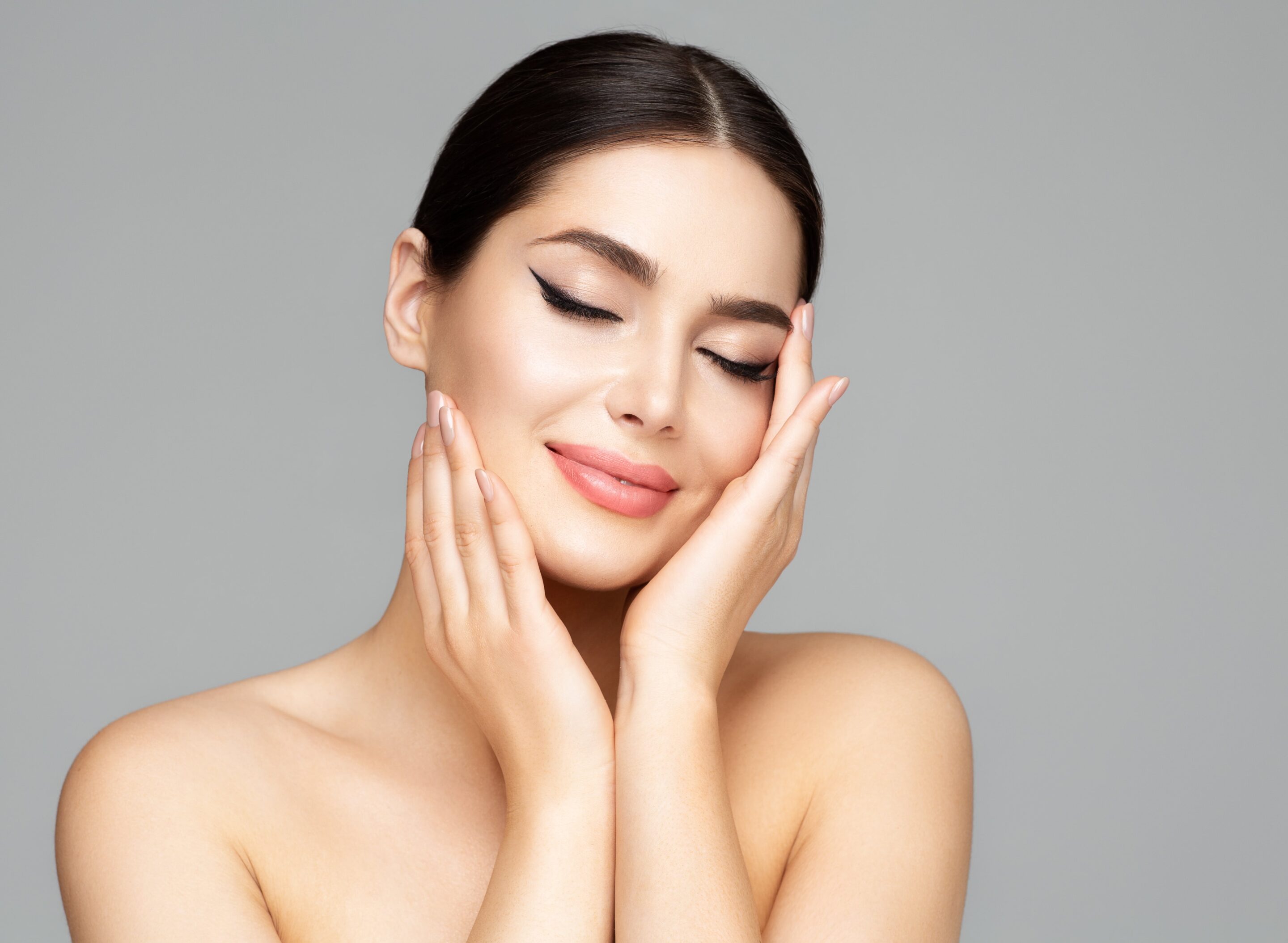 Woman face skin care beauty model holding face in hands